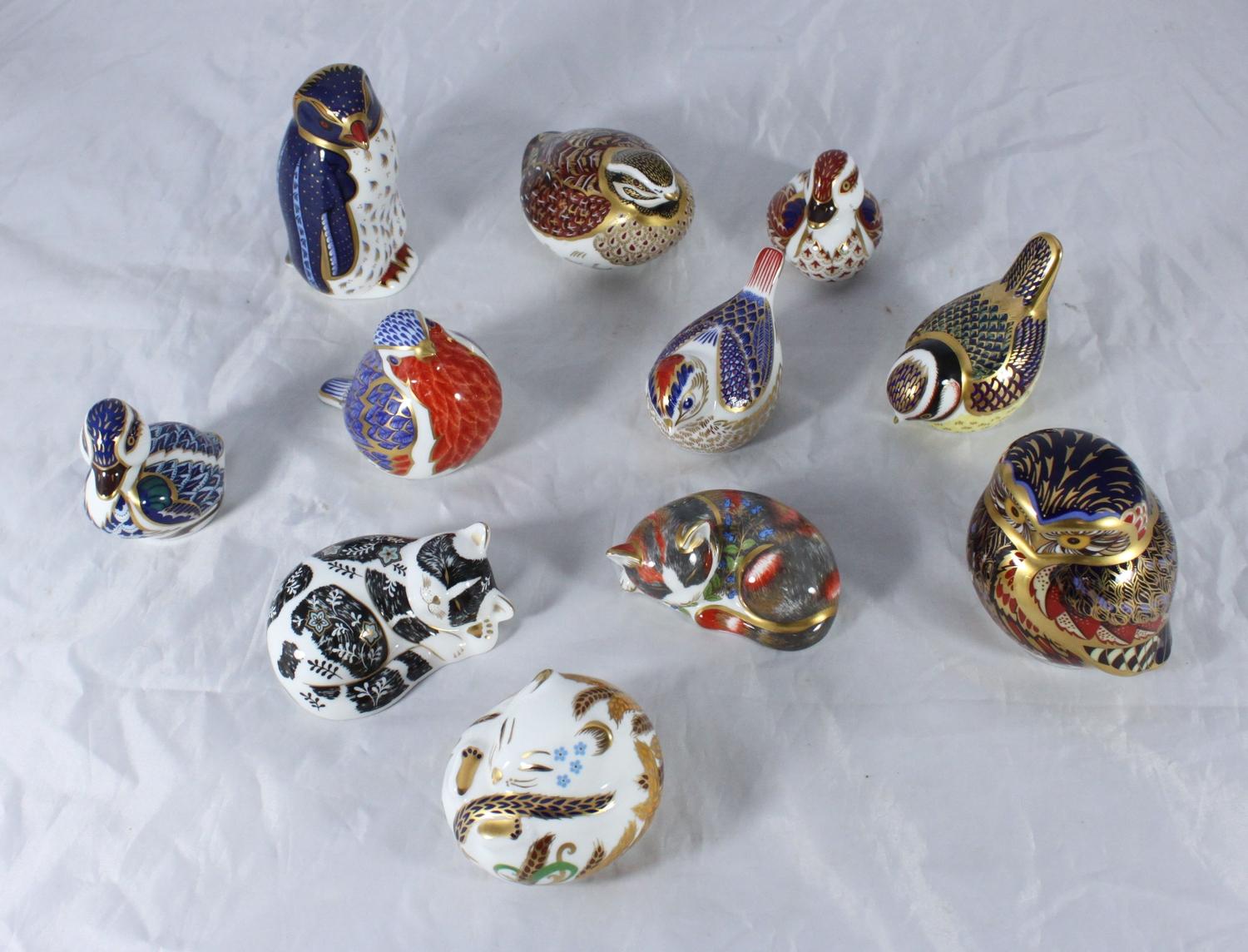 SECTION 36. Eleven assorted Royal Crown Derby ceramic paperweights modelled as birds and a cat etc.