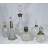 Four various silver topped/collared glass perfume bottles together with a white metal collared