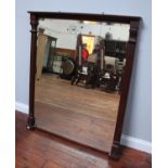 An Edwardian stained walnut over mantel mirror of rectangular form with fluted pilasters and