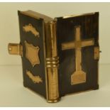 A Victorian heavy quality brass-bound box in the form of a book, the hinged lid revealing a red