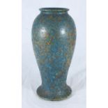 A Ruskin mottled pottery vase, of inverted baluster form with spreading foot, decorated in blue