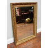 A rectangular bevelled mirror in ornate, gilt-wood frame, 65 x 92cm including frame