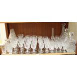 A collection of assorted glassware comprising three decanters and stoppers, a set of five Royal