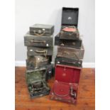 Twelve assorted vinyl cased portable gramophones and two typewriters by various makers for spares or