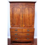 A 19th century flame mahogany linen press, the pair of panelled doors enclosing five sliding