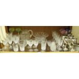 A shelf of assorted glassware including a set of six wine glasses, five various coloured glasses,