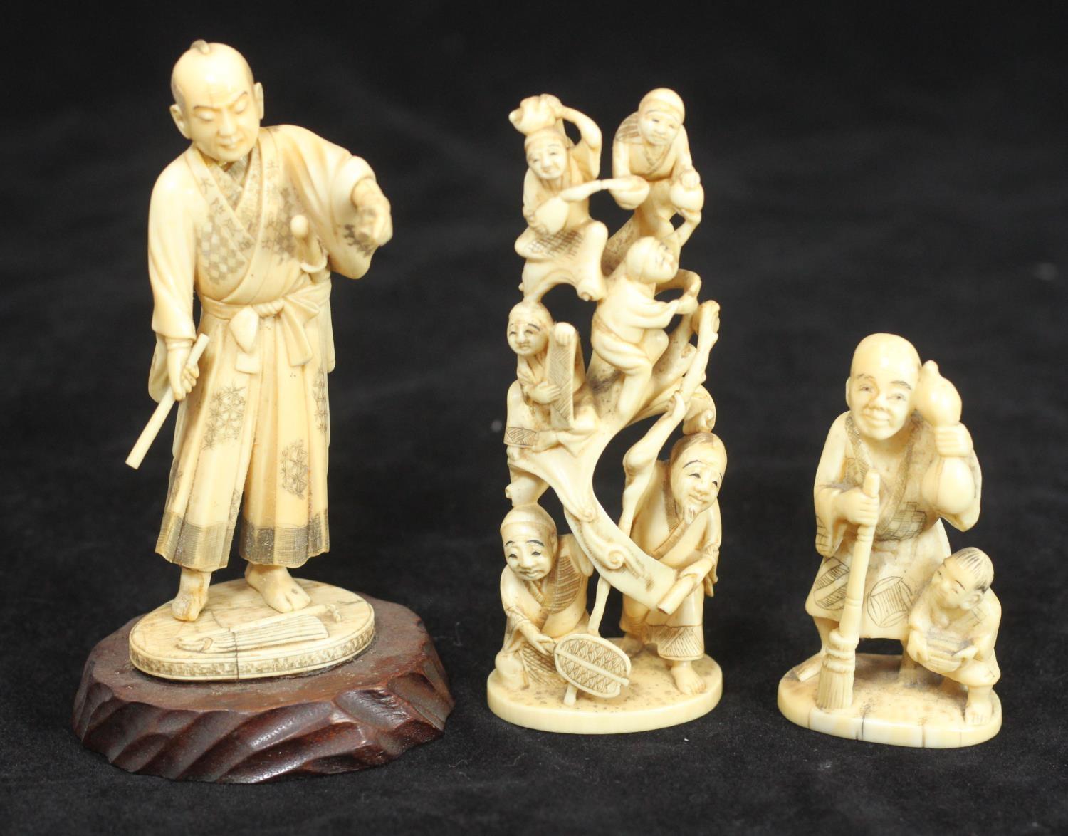 Three various carved ivory Okimono figures, one a group of acrobats, one a man in traditional