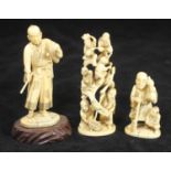 Three various carved ivory Okimono figures, one a group of acrobats, one a man in traditional