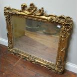 A rectangular wall mirror in ornately carved gilt gesso frame, 81 x 90cm