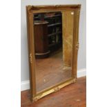 A rectangular bevelled mirror in ornately carved gilt frame, 105 x 75cm