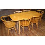 An Ercol light elm dining table of rectangular form, raised on squared, tapering supports, 150 x