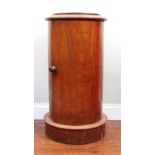 A Victorian mahogany cylindrical pot cupboard, the door opening to reveal two shelves, 73cm tall