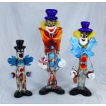Three various large Murano glass clowns, the largest holding a ball, measuring approx. 41cm high (3)