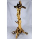 A driftwood crucifix with a carved figure of Christ, 74cm tall