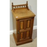 An Edwardian walnut and satinwood triple wardrobe-linen press, with central mirrored door