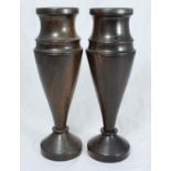 A pair of hardwood vases of tapering cylindrical form, raised on splayed foot-rim, 27cm tall