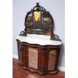 A Victorian burr-walnut credenza of serpentine form, with shaped and carved raised mirror back,