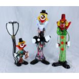 Three various large Murano glass clowns, one leaning up against a lamp post, the tallest 38cm