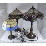 Two various large Tiffany style lamps decorated with stylised flowers, together with a smaller