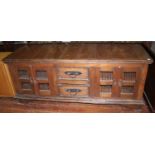 A teak low sideboard or food hutch, the two central drawers flanked by two cupboards, each with