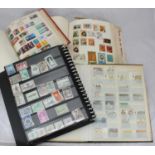 Four schoolboy stamp albums containing used GB and world, predominantly hinge mounted, some loose