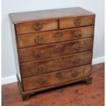 A George III mahogany chest of two short and four long graduated drawers, with pierced brass handles