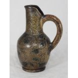 A Martin Brothers stoneware ewer by Robert Wallace Martin, in brown glaze, with incised stylised