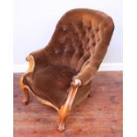 A Victorian walnut tub armchair, with scrolled arm terminals and front supports, deep-button brown