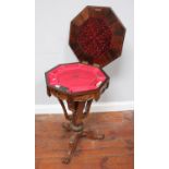 A Victorian rosewood octagonal workbox, the hinged top enclosing fabric lined compartmented interior