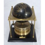 The Royal Geographical Society World Clock, 1988, gilt metal square frame supporting a black and