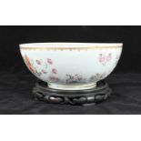 A Chinese porcelain armorial punch bowl, decorated with coats of arms and flowers in polychrome
