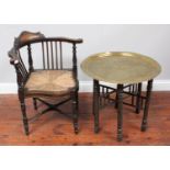 A late 19th century rush-seated corner chair and brass-top circular table with folding wooden base