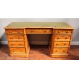 A Victorian satinwood inverted breakfront twin-pedestal desk, with inset gilt-tooled green leather