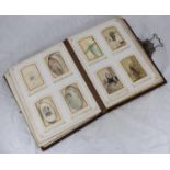 A Victorian musical Carte de Viste photograph album with brown leather boards embossed with