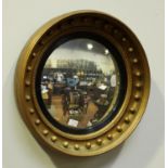 A Regency style gilt convex circular mirror with applied ball decoration and inner ebonised fluted