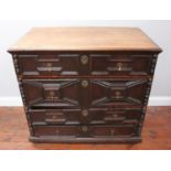 A late 17th century oak chest of four long graduated oak-lined drawers, with geometric applied