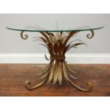 A circular glass-topped occasional table raised on gilt metal corn sheaf, approx. 70cm wide,
