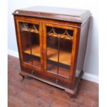 An early 20th century burr walnut veneered display cabinet, with bead & reel moulded caddy top above