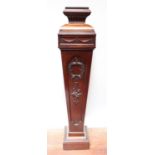 An early 20th century stained walnut pedestal torchere stand, of tapering square section, with