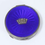 A silver and Royal blue enamel circular compact by Gieves Ltd, the lid mounted with a naval coronet,