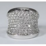 An 18ct white gold saddle ring, pave-set with 119 round brilliant-cut diamonds. The diamonds being H