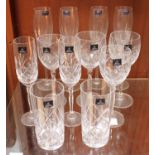 A small collection of twelve assorted drinking glasses, comprising a set of four champagne flutes