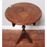 A small Gothic revival oak table in the style of Augustus Pugin, the circular top above a tripartite