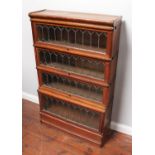 An oak four-section Globe Wernicke bookcase, two sections with 'Globe Wernicke' labels and two