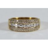 An 18ct gold three row ring, channel-set with seven baguette diamonds to the centre and pave-set