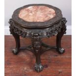 A Chinese carved hardwood low jardiniere stand, with inset shaped rouge marble top and carved