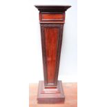 An early 20th century stained mahogany pedestal torchere stand of tapering square section, with