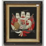 A silk and silver thread work naval crest depicting red ensign and white naval ensign flags and a