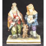 A 19th century German porcelain figure group, with two vagabonds in shabby clothes, one playing a