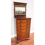 An early 20th century mahogany dressing chest with platform mirror above six graduated oak-lined